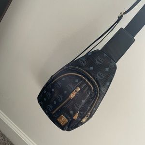 It’s a black & blue MCM across the shoulder fanny pack bag.